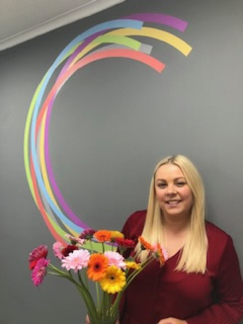 Paige of Compass Point receiving flowers from happy Administration candidate